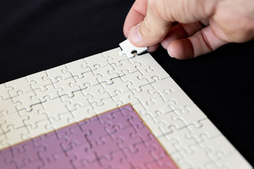 Entering final corner piece in jigsaw puzzle
