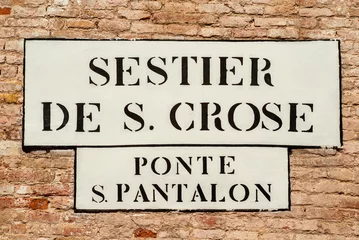 Fototapeten 'Sestier de S. Crose ' (Saint Cross District) and 'Ponte S. Pantalon' (St Pantaleon Bridge) old traditional road sign on a wall in Venice © crisfotolux