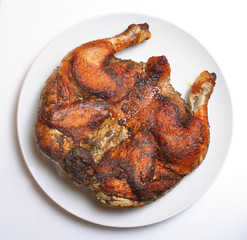 Grilled fried roast Chicken Tabaka on white plate
