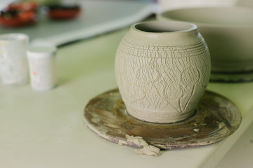 working with clay on potter's wheel, closeup of hands, crafts and arts