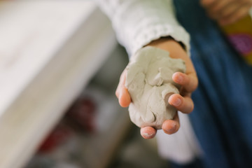 working with clay on potter's wheel, closeup of hands, crafts and arts