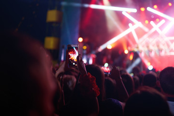 Use advanced mobile recording, fun concerts and beautiful lighting, Candid image of crowd at rock...