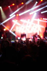Use advanced mobile recording, fun concerts and beautiful lighting, Candid image of crowd at rock...