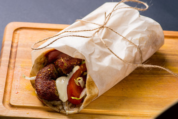 giros with vegetables and falafel, sprinkled with sauces