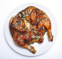 Grilled fried roast Chicken Tabaka on white plate
