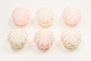 Fototapeta premium Rose marshmallows on white background. Zephyr.