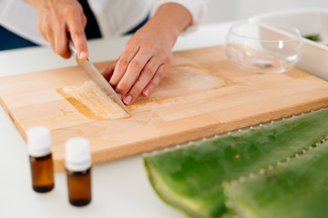 Woman preparing an aloe vera gel recipe with essences. Healthy, natural and cosmetic concept