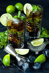 Cocktail Cuba libre   in glass on dark background