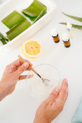Woman preparing an aloe vera gel recipe with essences. Healthy, natural and cosmetic concept