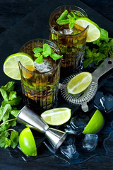Cuba libre cocktail with rum, cola and lime, holidays party concept.