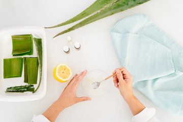 Woman preparing an aloe vera gel recipe with essences. Healthy, natural and cosmetic concept
