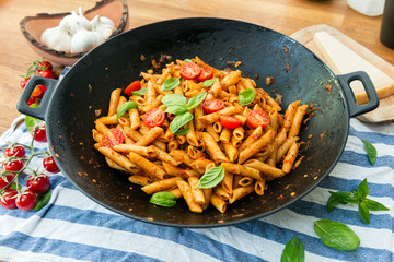 Penne pasta in tomato sauce with basil