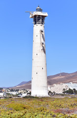 Fototapeta na wymiar Lighthouse on Morro Jable beach on Jandia peninsula in sunrise light, Fuerteventura, Canary Islands, Spain
