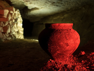 Old pot in the cave in red light