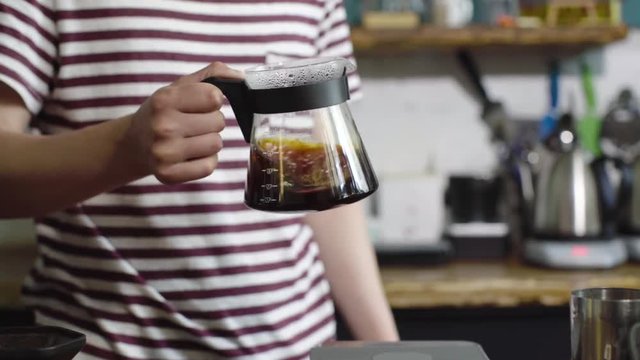 Cinemagraph of professional barista mixing blubing hario french filter coffee pot