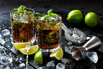Cuba libre cocktail with rum, cola and lime, holidays party concept.
