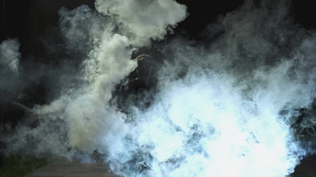 The male going in the cloud of smoke. evening night time, slow motion