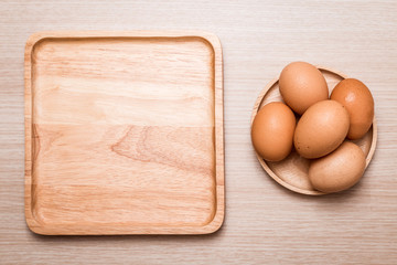 Close-up view of chicken eggs on wooden table background