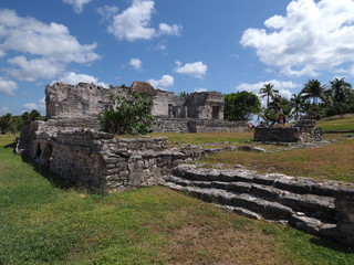 Fototapeta na wymiar Archaeological site and ancient ruins of stony mayan temple at TULUM city at Mexico on grassy field