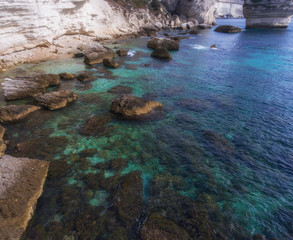 Turquoise clear waters near the rocky coast of the island of Corsica