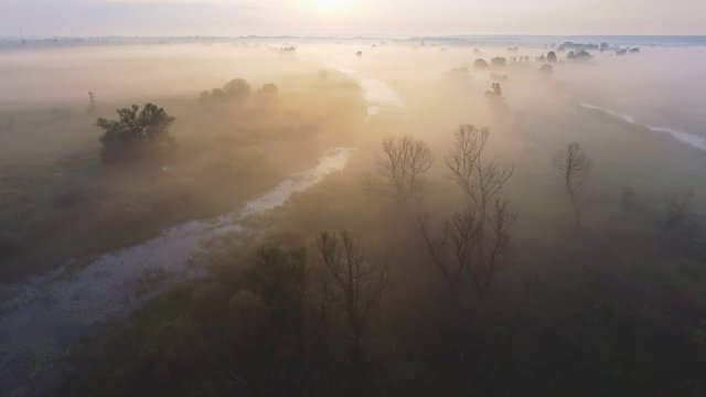Aerial footage video of foggy morning. Flying over the Desna river. Sunrise time. Kyiv region, Ukraine.