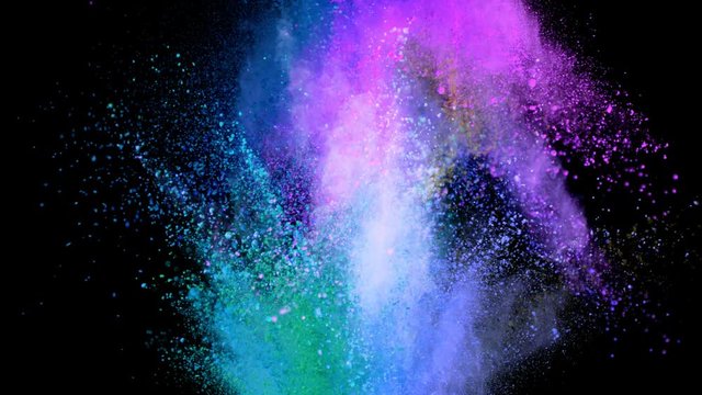 Super slowmotion shot of color powder explosions isolated on black background. Shot with high speed cinema camera at 1000fps