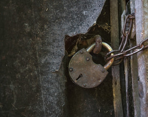 old rusty metal padlock on a door
