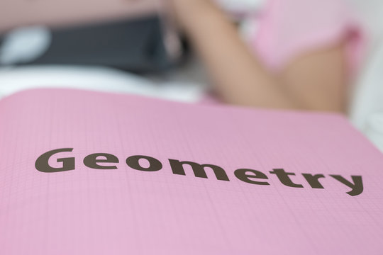 Geometry chapter on math textbook with blur background of asia student school girl studying - Powered by Adobe