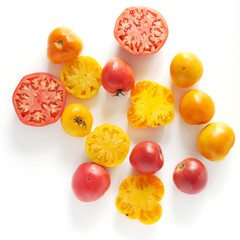 Red and yellow tomatoes isolated on white background, top view.
