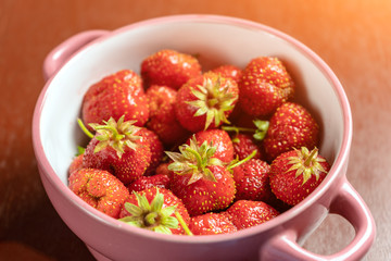 Fresh strawberries are only collected from the garden to the plate. Toned glow