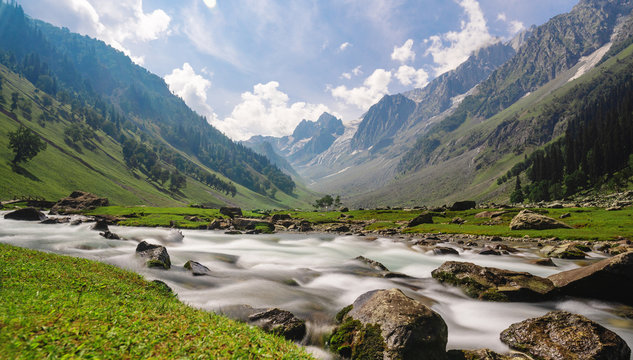 Scenic long exposure water flowing in river with mountain landscape in Sonamarg, Jammu and Kashmir, India