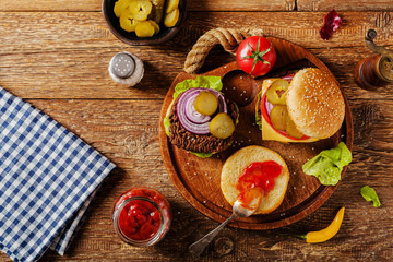 Homemade, beef hamburger with cheese and vegetables.