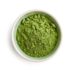 Bowl of matcha powder isolated on white background, top view