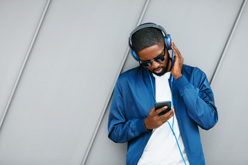 Man Listening Music In Headphones On Phone In Street. 