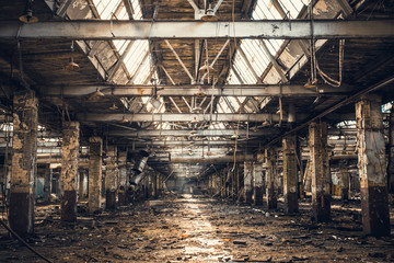 Abandoned ruined industrial warehouse or factory building inside, corridor view with perspective, ruins and demolition concept - obrazy, fototapety, plakaty