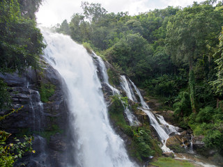 Wide detail of the large and powerful Wachirathan falls on a cloudy day with water spraying. Chom Thong, Chiang Mai, Thailand. Travel and nature.