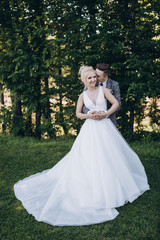 Fototapeta premium Walking newlyweds in nature.