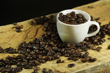 Composition of a cup of coffee with many coffee beans around. Concept: drink, breakfast