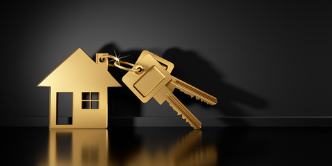 Goldener Schlüssel mit Anhänger in Hausform 