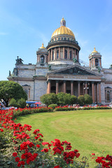 St. Isaac's Cathedral in Saint Petersburg, Russia. Orthodox Church and Museum Building, Famous Cultural Architecture Landmark. Saint Isaac Cathedral Front View with Rose Flowers on Sunny Summer Day