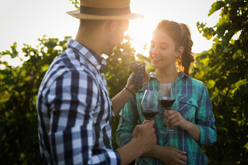 People tasting wine in vineyard