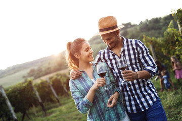 People tasting wine in vineyard