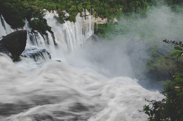 Kalandula waterfalls of Angola in full flow with lush green rain forest, rocks and spray, Africa