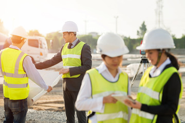 View of a Construction manager architect checking plan on construction site.