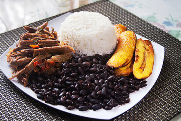 Homemade Venezuelan food. Traditional Venezuelan dish. Pabellon Criollo. White Rice, Black...