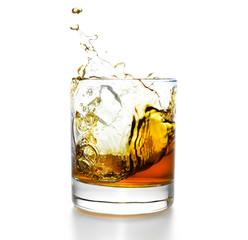 Whisky glass with splashes, isolated on white