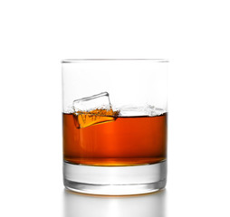 Whisky glass with splashes, isolated on white