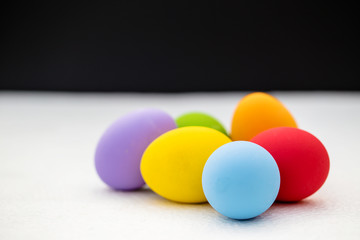 Colorful Easter eggs background. holiday, easter background. Colorful easter eggs on the green garden yard. symbol of easter's day festival. vivid color natural background. festive wallpaper.