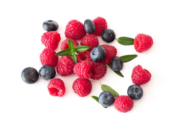 Blueberries and raspberries on white background.
