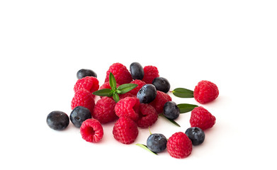 Blueberries and raspberries on white background.